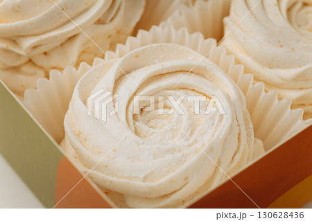 Delicate vanilla marshmallows in elegant packaging, soft swirl texture, close-up Delicate vanilla marshmallows in elegant packaging, soft swirl texture, close-up 130628436
