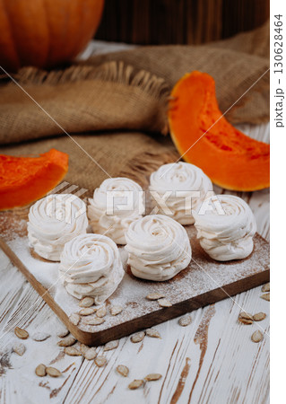 Autumn pumpkin marshmallows on rustic wooden background with seeds and burlap Autumn pumpkin marshmallows on rustic wooden background with seeds and burlap 130628464