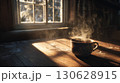 窓辺に置かれた湯気の立つコーヒーカップ 130628915