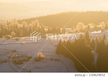 Winter Mountain Village At Sunrise With Snowy Slopes And Frosted Trees 130629032