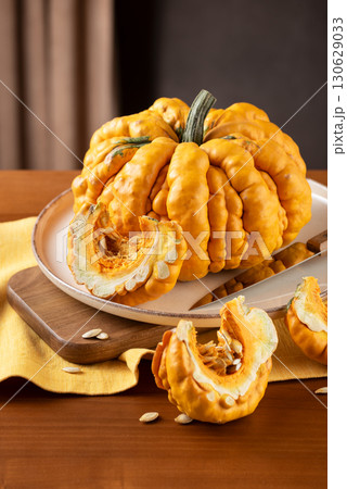 Guicoy Pumpkin And Wedges Prepared On Kitchen Table Guicoy Pumpkin And Wedges Prepared On Kitchen Table 130629033