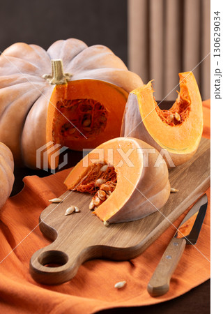 Cut Musquee De Provence Pumpkin On Kitchen Table Cut Musquee De Provence Pumpkin On Kitchen Table 130629034