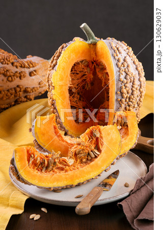 Cut Musquee De Maroc Pumpkin With Orange Flesh On Kitchen Table Cut Musquee De Maroc Pumpkin With Orange Flesh On Kitchen Table 130629037