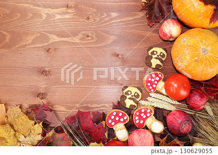 Thanksgiving, autumn background with seasonal autumn nature berries, pumpkins, apples and flowers on a wooden background, copy space, happy thanksgiving concept, selective focus. Thanksgiving, autumn background with seasonal autumn nature berries, pumpkins, apples and flowers on a wooden background, copy space, happy thanksgiving concept, selective focus. 130629055