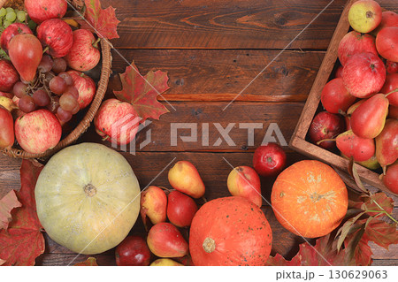 Happy Thanksgiving concept, postcard Autumn background with seasonal pears, pumpkins, apples and flowers on wooden background, copy space, selective focus. Harvesting, gifts of nature Happy Thanksgiving concept, postcard Autumn background with seasonal pears, pumpkins, apples and flowers on wooden background, copy space, selective focus. Harvesting, gifts of nature 130629063