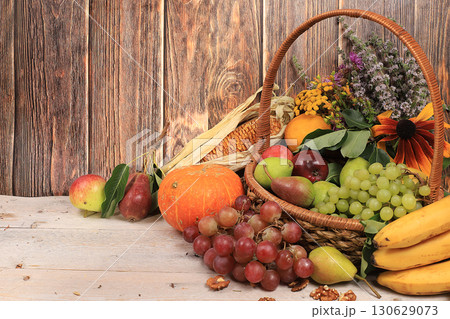 Healthy natural food, vegan diet.Happy Thanksgiving concept, Autumn background with seasonal autumn nature berries, pumpkins, apples and flowers on a wooden background, selective focus. Healthy natural food, vegan diet.Happy Thanksgiving concept, Autumn background with seasonal autumn nature berries, pumpkins, apples and flowers on a wooden background, selective focus. 130629073