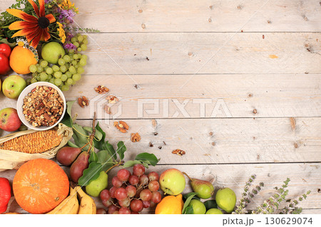 Autumn background with seasonal nature autumn berries, pumpkins, apples and flowers on wooden background, healthy natural food, vegan diet.Happy Thanksgiving concept, selective focus. Autumn background with seasonal nature autumn berries, pumpkins, apples and flowers on wooden background, healthy natural food, vegan diet.Happy Thanksgiving concept, selective focus. 130629074