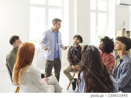Male speaker at psychologist meeting patients at group therapy, team counselor giving advices Male speaker at psychologist meeting patients at group therapy, team counselor giving advices 130631945
