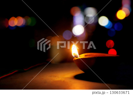 Traditional Clay Oil Lamp with Colorful Bokeh Lights at Night Traditional Clay Oil Lamp with Colorful Bokeh Lights at Night 130633671