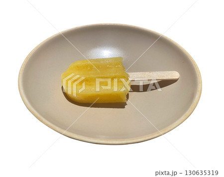 Yellow Popsicle on White Plate with Natural Light, isolated transparent background 130635319