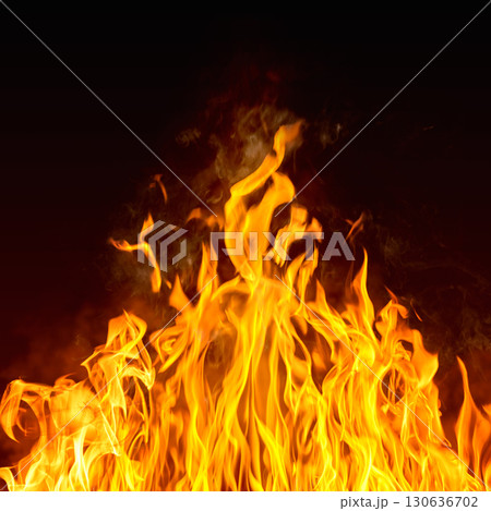 Dramatic red, orange, yellow flame and smoke rising against a dark background. Realistic, abstract fire burning background texture overlay. Vivid and hot hell or blazing fire wallpaper 130636702