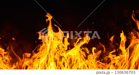 Dramatic red, orange, yellow flame and smoke rising against a dark background. Realistic, abstract fire burning background texture overlay. Vivid and hot hell or blazing fire wallpaper Dramatic red, orange, yellow flame and smoke rising against a dark background. Realistic, abstract fire burning background texture overlay. Vivid and hot hell or blazing fire wallpaper 130636703