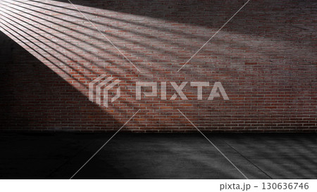 Striking light beam shines across the interior of the room with red brick walls and a concrete floor. Mockup, copy space, or template. Empty backdrop podium for product or text display 130636746