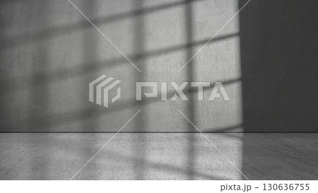 Dramatic shadow of window light shines across the interior of the room with a gray wall and floor background. Mockup, copy space, or template. Empty backdrop podium for product or text display Dramatic shadow of window light shines across the interior of the room with a gray wall and floor background. Mockup, copy space, or template. Empty backdrop podium for product or text display 130636755