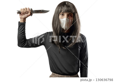 Indonesian southeast asian transgender man dressed as a woman wearing a bloody face mask and holding a bloody knife isolated over a white background. Concept of Halloween, Sister Hong, or red uncle Indonesian southeast asian transgender man dressed as a woman wearing a bloody face mask and holding a bloody knife isolated over a white background. Concept of Halloween, Sister Hong, or red uncle 130636798