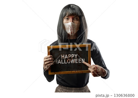 Indonesian southeast asian transgender man dressed as a woman wearing a bloody face mask and showing the text of Happy Halloween on a blackboard. Concept of Halloween, Sister Hong, or red uncle 130636800