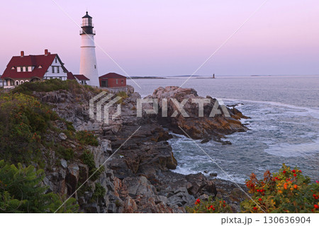 Portland Head Light in late afternoon surrounded by with dramatic waves and cliffs, Maine, USA 130636904