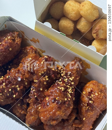 Crispy Korean fried chicken, perfectly glazed with a sweet and spicy sauce. Ideal for food photography and menus, showcasing the irresistible crunch and flavor of this beloved dish. Crispy Korean fried chicken, perfectly glazed with a sweet and spicy sauce. Ideal for food photography and menus, showcasing the irresistible crunch and flavor of this beloved dish. 130638697