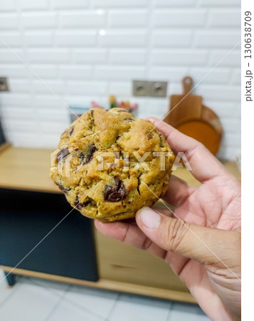 Freshly baked cookies with a golden-brown finish and chocolate chips. Perfectly crisp on the edges with a soft center, offering a delicious, comforting treat for any occasion. 130638709