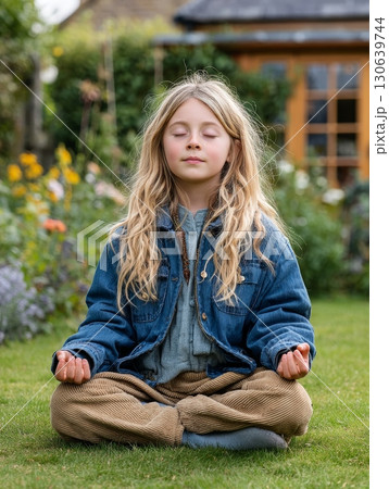 Serene Child Meditating Outdoors in a Lush Garden Surrounded by Colorful Flowers Serene Child Meditating Outdoors in a Lush Garden Surrounded by Colorful Flowers 130639744