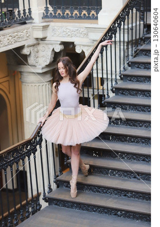 Ballet dancer posing on historic staircase outdoors Ballet dancer posing on historic staircase outdoors 130640604