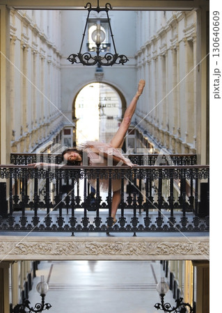 Ballet dancer on balcony in classical archway Ballet dancer on balcony in classical archway 130640609