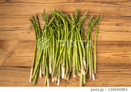 Bunch of Raw Garden Asparagus on Wood Rustic Tabletop. Fresh Green Spring Vegetables 130640965