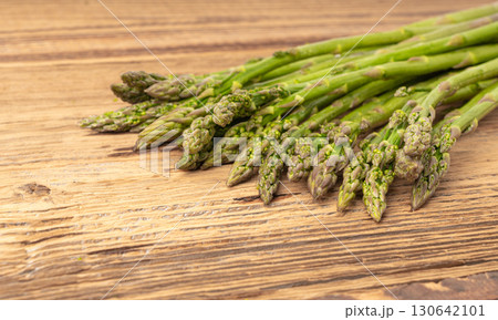Bunch of Raw Garden Asparagus on Wood Rustic Tabletop. Fresh Green Spring Vegetables 130642101