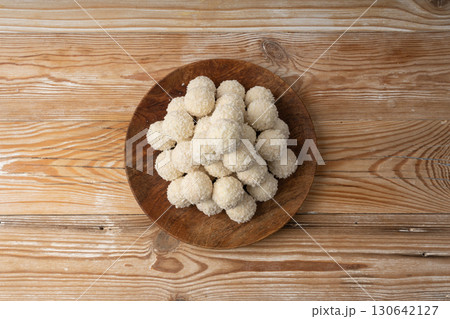 Coconut candies pile, coco ball. White truffle ball, indian ladoo or laddu with sweet cream and coco Coconut candies pile, coco ball. White truffle ball, indian ladoo or laddu with sweet cream and coco 130642127