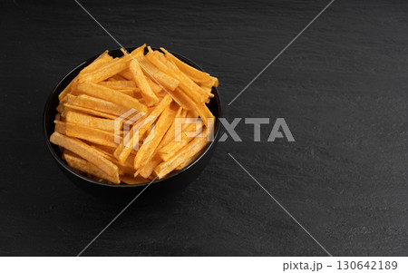 Fried chips sticks, finger potato chips, golden shoestring fries pile, French fries Fried chips sticks, finger potato chips, golden shoestring fries pile, French fries 130642189