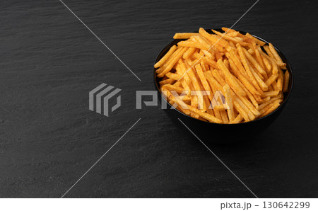 Fried chips sticks, finger potato chips, golden shoestring fries pile, French fries Fried chips sticks, finger potato chips, golden shoestring fries pile, French fries 130642299