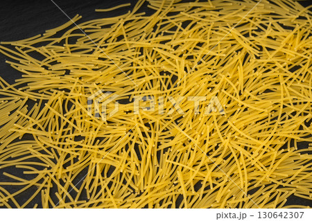Raw vermicelli textured background, gold soup pasta pattern, small homemade noodles mock up Raw vermicelli textured background, gold soup pasta pattern, small homemade noodles mock up 130642307
