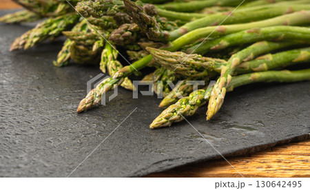 Bunch of Raw Garden Asparagus Textured Background. Fresh Green Spring Vegetables Bunch of Raw Garden Asparagus Textured Background. Fresh Green Spring Vegetables 130642495