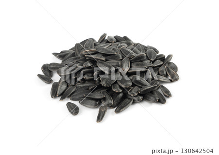 Sunflower seeds pile isolated, black oil sun flower grains group with shell, fresh edible oil seeds heap 130642504