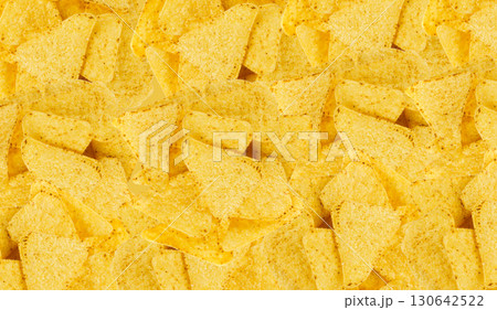 Heap of triangle corn chips pattern, food textured background 130642522