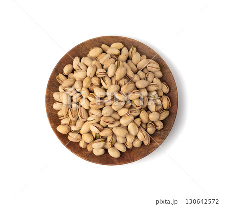 Fried salt pistachio nuts isolated. Baked pistachios pile, roasted green pistache fruit in shell on white 130642572