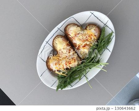 Golden, crispy toast topped with butter and jam, perfect for breakfast or snack-related projects. This image captures the warmth and comfort of a simple yet satisfying meal. 130643662