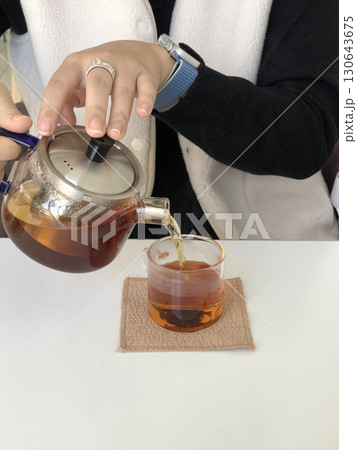A steaming cup of hot tea with a rich aroma and soothing warmth. Perfect for relaxation or a refreshing pick-me-up. Enjoy its comforting flavor plain or with a touch of honey. A steaming cup of hot tea with a rich aroma and soothing warmth. Perfect for relaxation or a refreshing pick-me-up. Enjoy its comforting flavor plain or with a touch of honey. 130643675