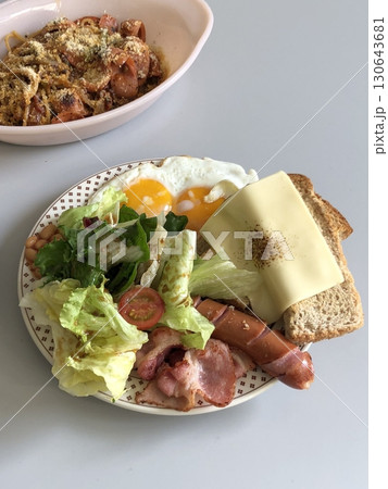 A delightful brunch spread featuring a mix of savory and sweet bites. perfectly toasted bread, fresh fruits, soft scrambled eggs, and a refreshing drink to brighten your late morning. A delightful brunch spread featuring a mix of savory and sweet bites. perfectly toasted bread, fresh fruits, soft scrambled eggs, and a refreshing drink to brighten your late morning. 130643681