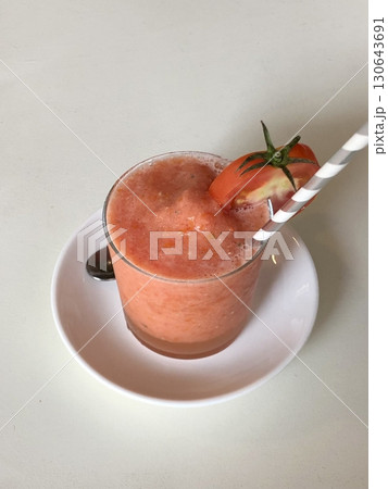 Refreshing tomato slushie with a blend of ripe, juicy tomatoes and ice, offering a perfect balance of natural sweetness, tangy flavor, and icy coolness in every revitalizing sip. Refreshing tomato slushie with a blend of ripe, juicy tomatoes and ice, offering a perfect balance of natural sweetness, tangy flavor, and icy coolness in every revitalizing sip. 130643691