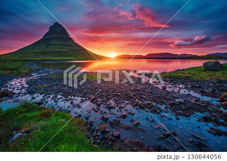 Majestic evening with Kirkjufell volcano. Popular tourist attraction. Location place Kirkjufellsfoss, Iceland, Europe. Majestic evening with Kirkjufell volcano. Popular tourist attraction. Location place Kirkjufellsfoss, Iceland, Europe. 130644056