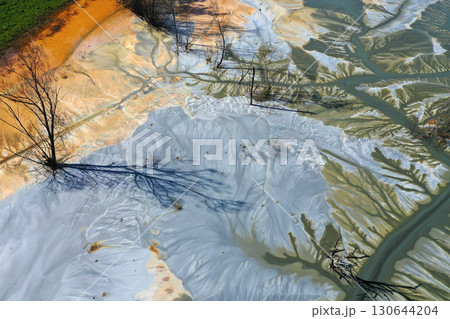 Abstract natural colorful patterns of acid mine drainage in decanting lake aerial view 130644204