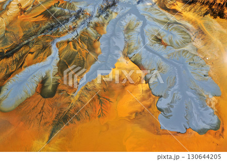 Abstract natural colorful patterns of acid mine drainage in decanting lake aerial view 130644205