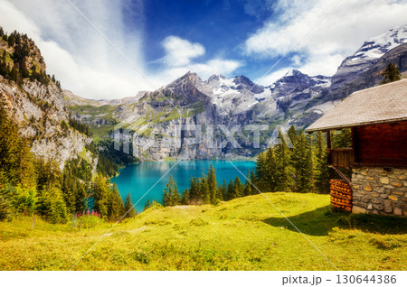 Great panorama of the azure pond Oeschinensee. Location Swiss alps, Kandersteg, Europe. Great panorama of the azure pond Oeschinensee. Location Swiss alps, Kandersteg, Europe. 130644386