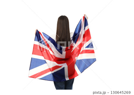 Person holds Union Jack flag while facing away, isolated on white, PNG 130645269