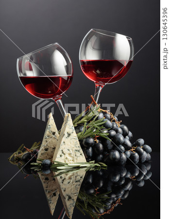 Red wine with grapes, rosemary, and blue cheese. 130645396