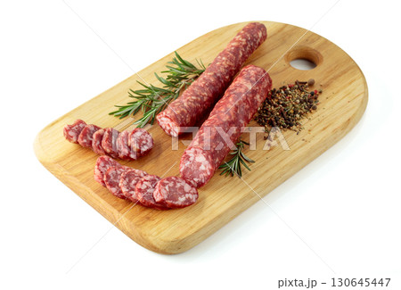 Sausages with rosemary and spices isolated on a white background. Sausages with rosemary and spices isolated on a white background. 130645447