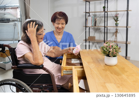 Elderly woman found her lost wallet in drawer. Dementia concept. 130645895