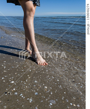Woman leg walking on beach. Woman leg walking on beach. 130648274