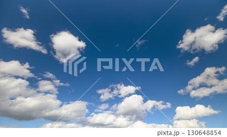 The beautiful blue sky adorned with fluffy white clouds creates a picturesque landscape 130648854